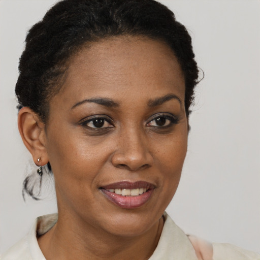 Joyful black young-adult female with short  brown hair and brown eyes