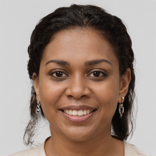 Joyful black young-adult female with medium  brown hair and brown eyes
