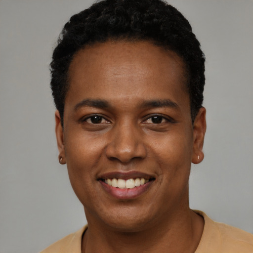 Joyful black young-adult male with short  black hair and brown eyes