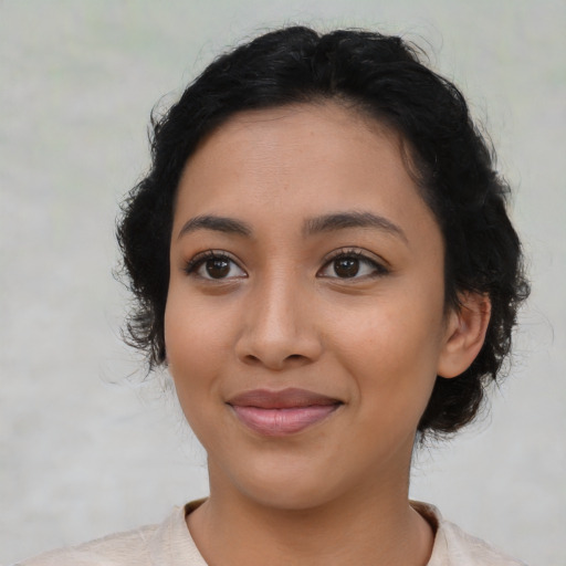 Joyful latino young-adult female with medium  black hair and brown eyes