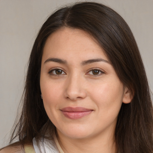 Joyful white young-adult female with long  brown hair and brown eyes