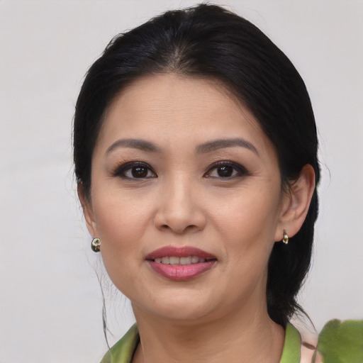 Joyful asian young-adult female with medium  brown hair and brown eyes