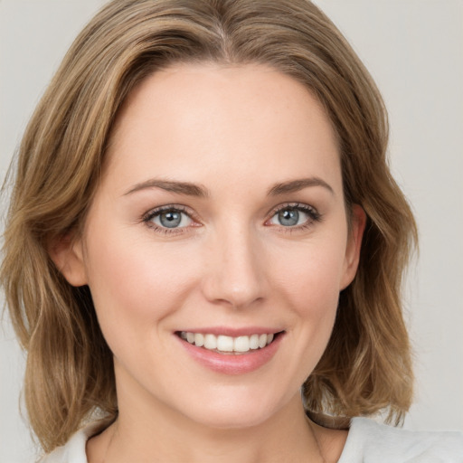 Joyful white young-adult female with medium  brown hair and green eyes