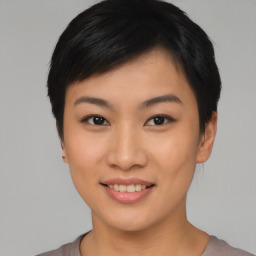 Joyful asian young-adult female with short  black hair and brown eyes