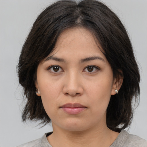 Neutral asian young-adult female with medium  brown hair and brown eyes