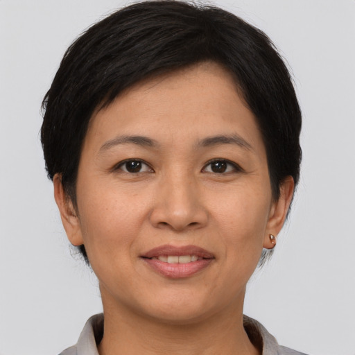Joyful asian young-adult female with short  brown hair and brown eyes