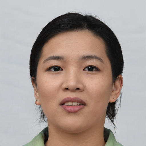 Joyful asian young-adult female with short  black hair and brown eyes