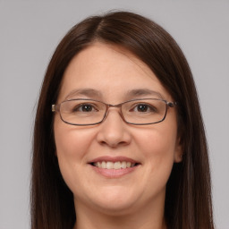 Joyful white adult female with long  brown hair and brown eyes