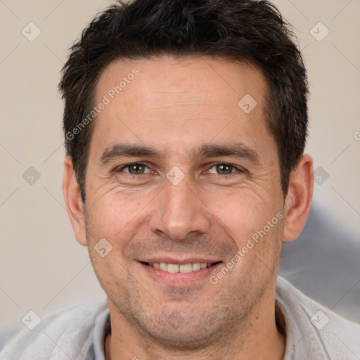 Joyful white adult male with short  brown hair and brown eyes