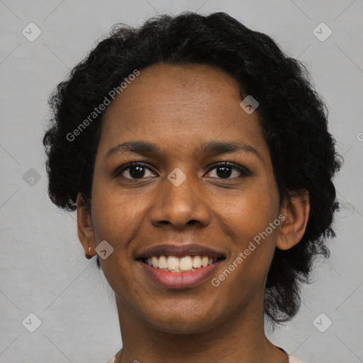 Joyful black young-adult female with short  black hair and brown eyes