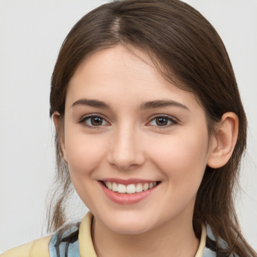 Joyful white young-adult female with medium  brown hair and brown eyes