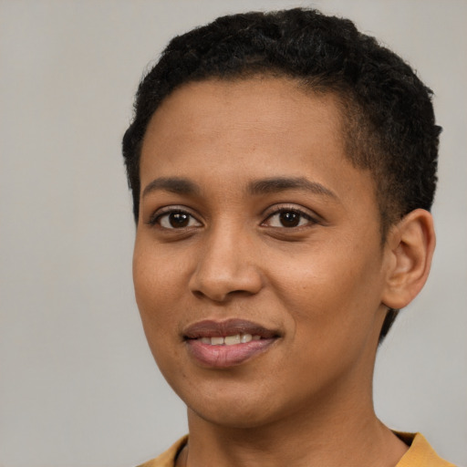 Joyful black young-adult female with short  brown hair and brown eyes