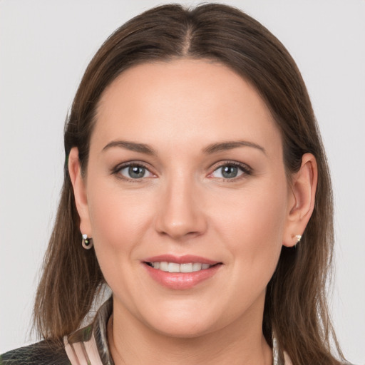 Joyful white young-adult female with medium  brown hair and grey eyes