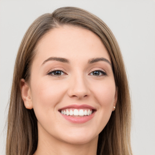 Joyful white young-adult female with long  brown hair and grey eyes