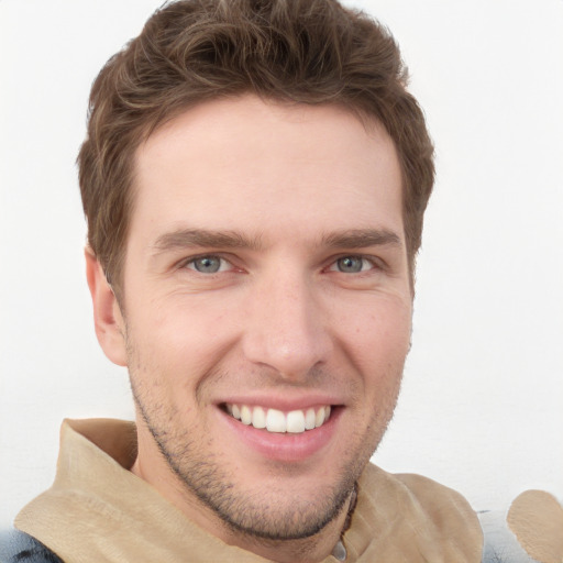 Joyful white young-adult male with short  brown hair and grey eyes