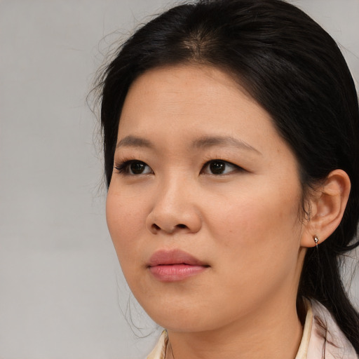 Joyful asian young-adult female with medium  black hair and brown eyes