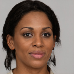 Joyful black adult female with medium  brown hair and brown eyes