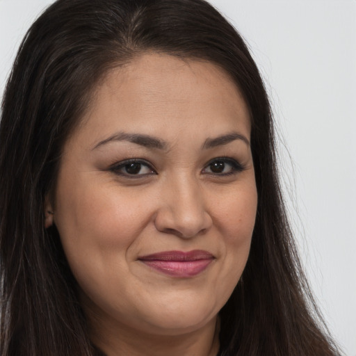 Joyful latino young-adult female with long  brown hair and brown eyes