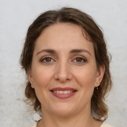 Joyful white young-adult female with medium  brown hair and green eyes