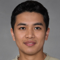 Joyful asian young-adult male with short  black hair and brown eyes