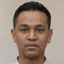 Neutral latino young-adult male with short  black hair and brown eyes