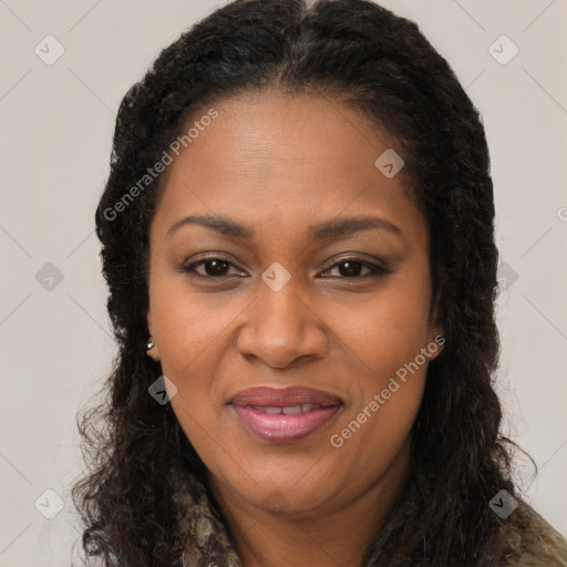 Joyful black adult female with long  brown hair and brown eyes