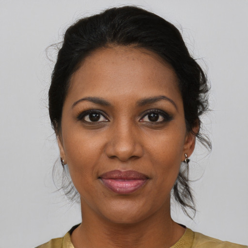 Joyful black young-adult female with medium  brown hair and brown eyes