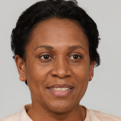 Joyful latino adult female with short  brown hair and brown eyes