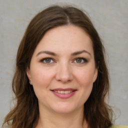 Joyful white young-adult female with medium  brown hair and green eyes