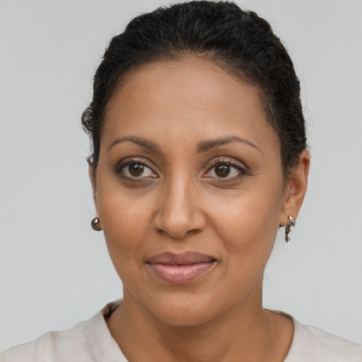 Joyful latino adult female with short  brown hair and brown eyes