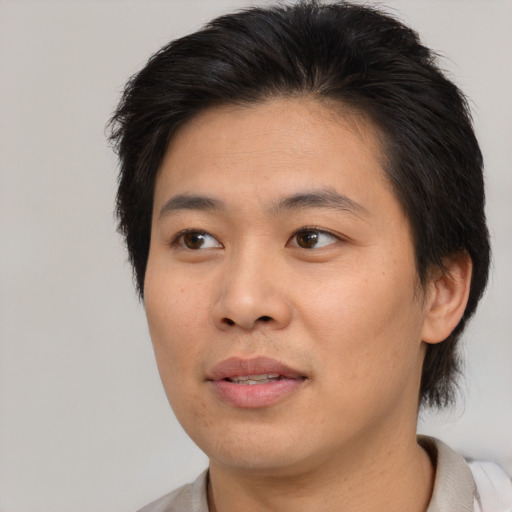 Joyful asian young-adult male with short  brown hair and brown eyes