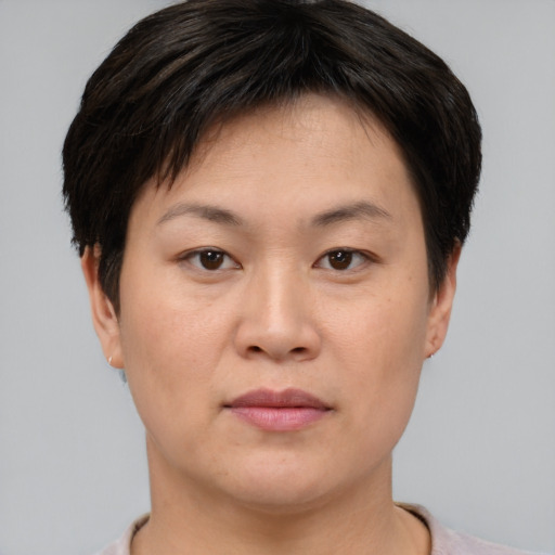 Joyful asian young-adult female with short  brown hair and brown eyes