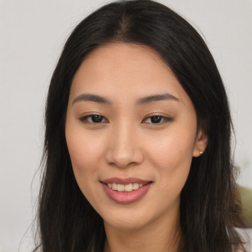 Joyful asian young-adult female with long  brown hair and brown eyes