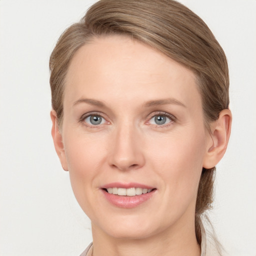 Joyful white young-adult female with medium  brown hair and blue eyes