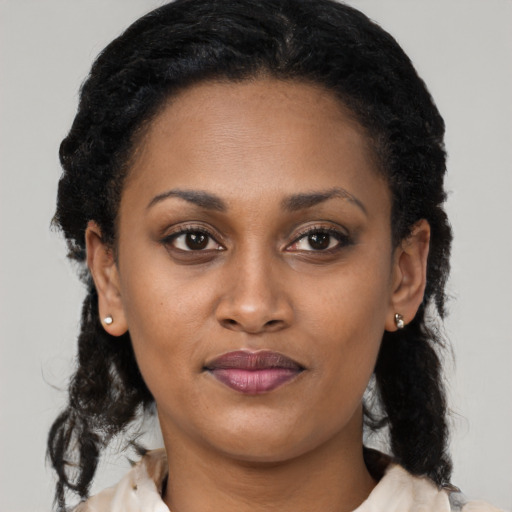 Joyful black young-adult female with medium  black hair and brown eyes
