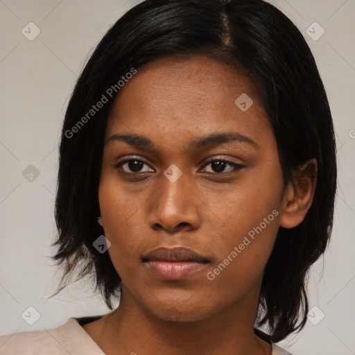 Neutral black young-adult female with medium  black hair and brown eyes