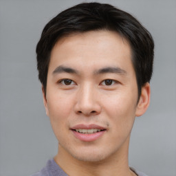 Joyful asian young-adult male with short  black hair and brown eyes