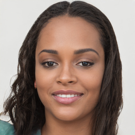 Joyful latino young-adult female with long  brown hair and brown eyes