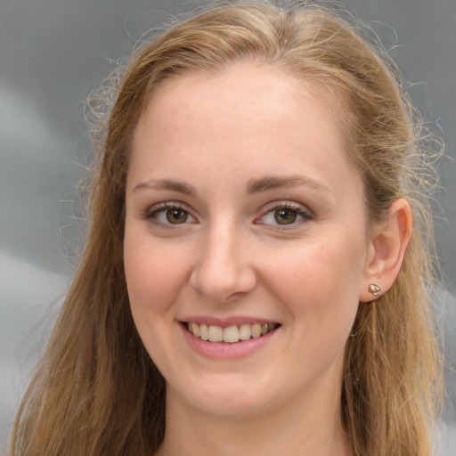 Joyful white young-adult female with long  brown hair and grey eyes