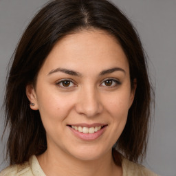 Joyful white young-adult female with medium  brown hair and brown eyes