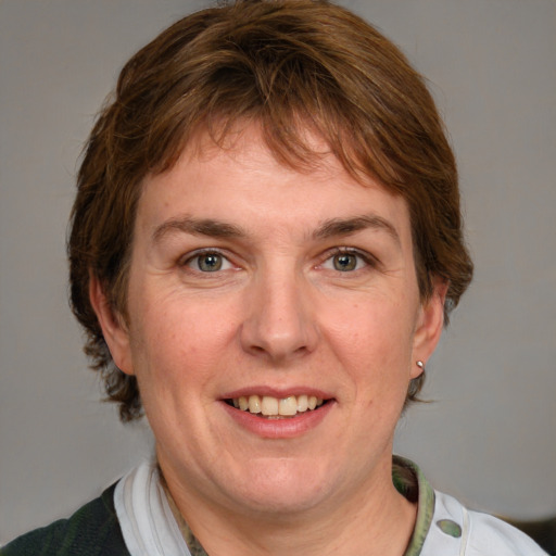 Joyful white adult female with medium  brown hair and grey eyes