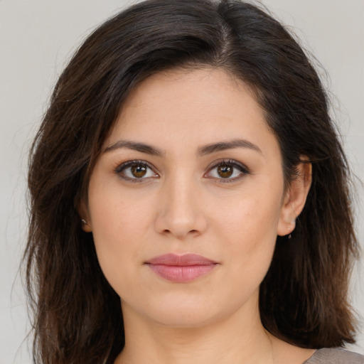 Joyful white young-adult female with long  brown hair and brown eyes