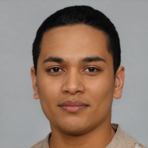 Joyful latino young-adult male with short  black hair and brown eyes