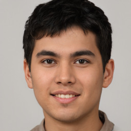 Joyful asian young-adult male with short  brown hair and brown eyes