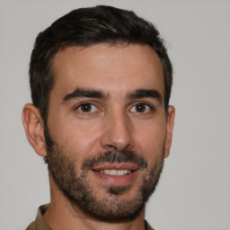 Joyful white young-adult male with short  brown hair and brown eyes