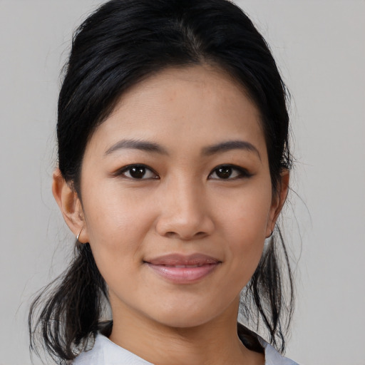 Joyful asian young-adult female with medium  black hair and brown eyes