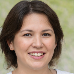 Joyful white adult female with medium  brown hair and brown eyes