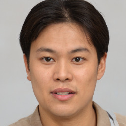 Joyful asian young-adult male with short  brown hair and brown eyes