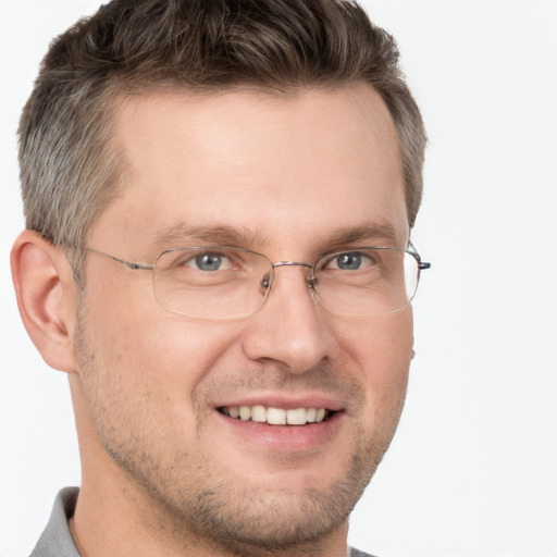 Joyful white adult male with short  brown hair and brown eyes