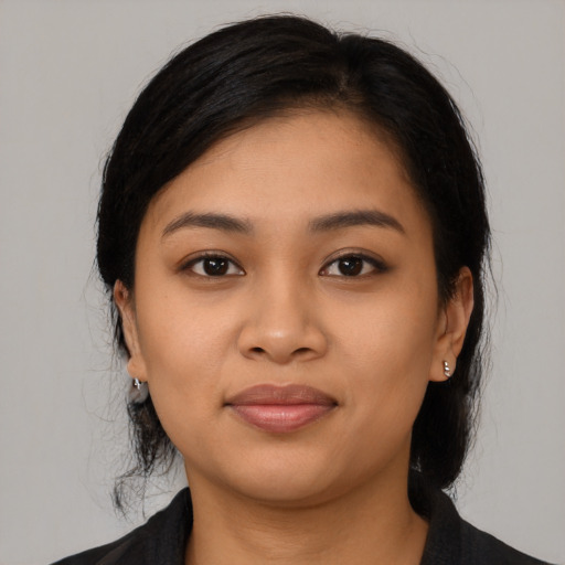 Joyful latino young-adult female with medium  black hair and brown eyes